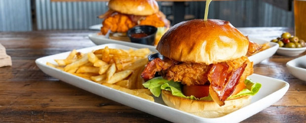 Burgers and fries served on rectangular plates