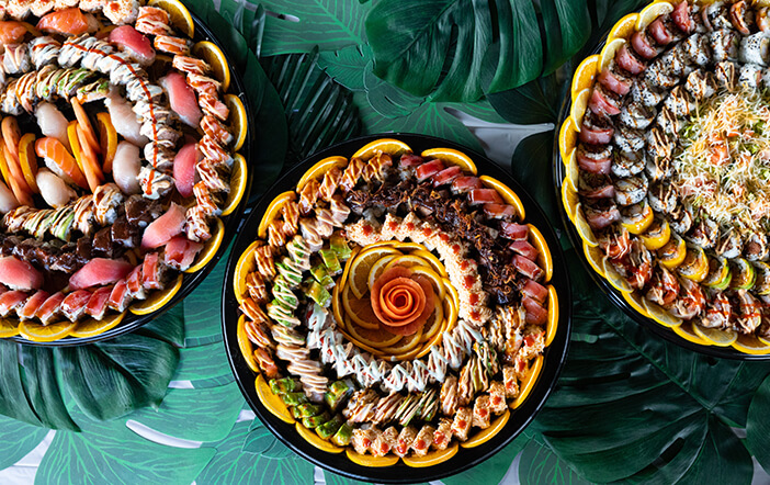 Sushi platters filled with rolls and sliced fish