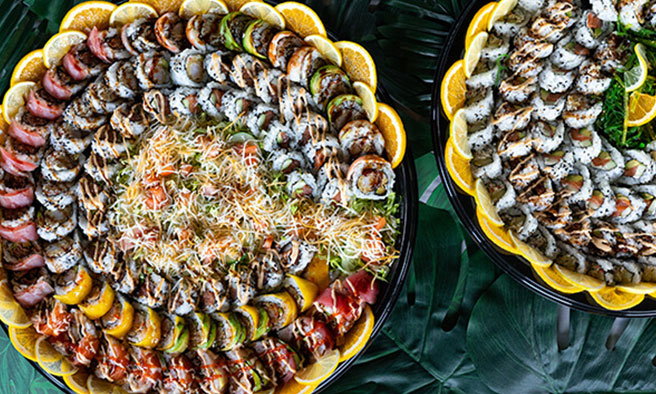 A large sushi platter arranged with rolls and sliced fish