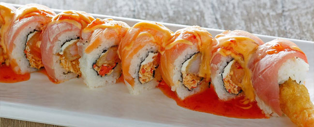 Sushi rolls arranged on a white rectangular plate