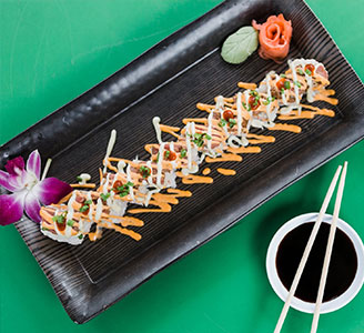 A long sushi roll platter served with chopsticks